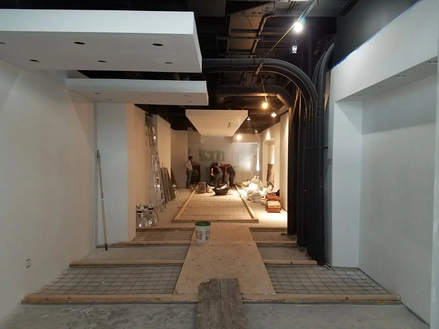 Floating ceiling and tile layout in progress in the Downtown Brooklyn pharmacy