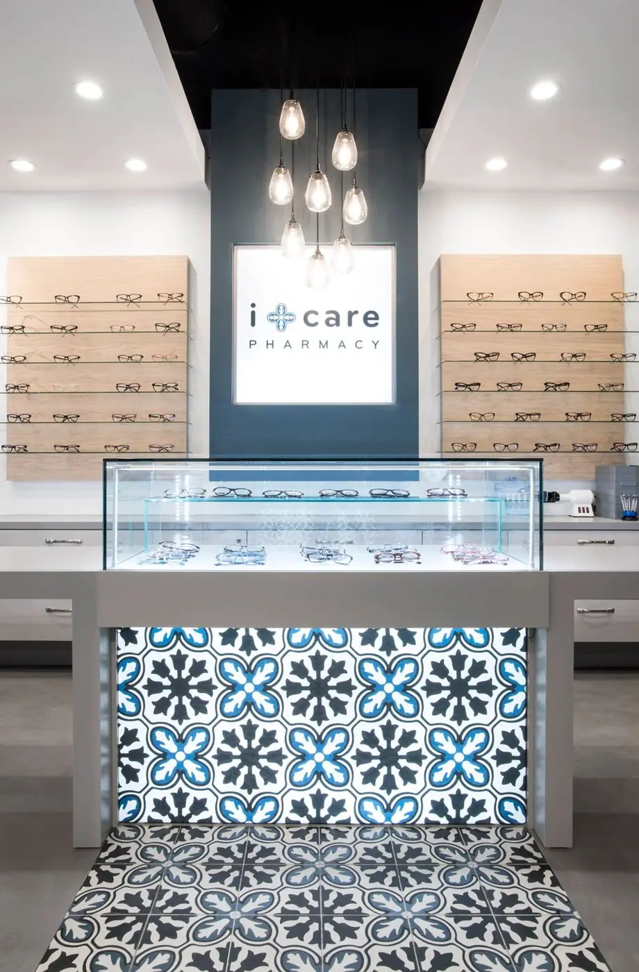 Backlit eyewear wall and glass counter in the finished Brooklyn optical store