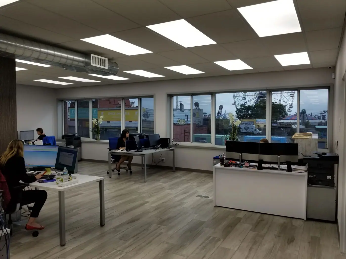 Finished open plan office with new lighting, flooring and a reception counter
