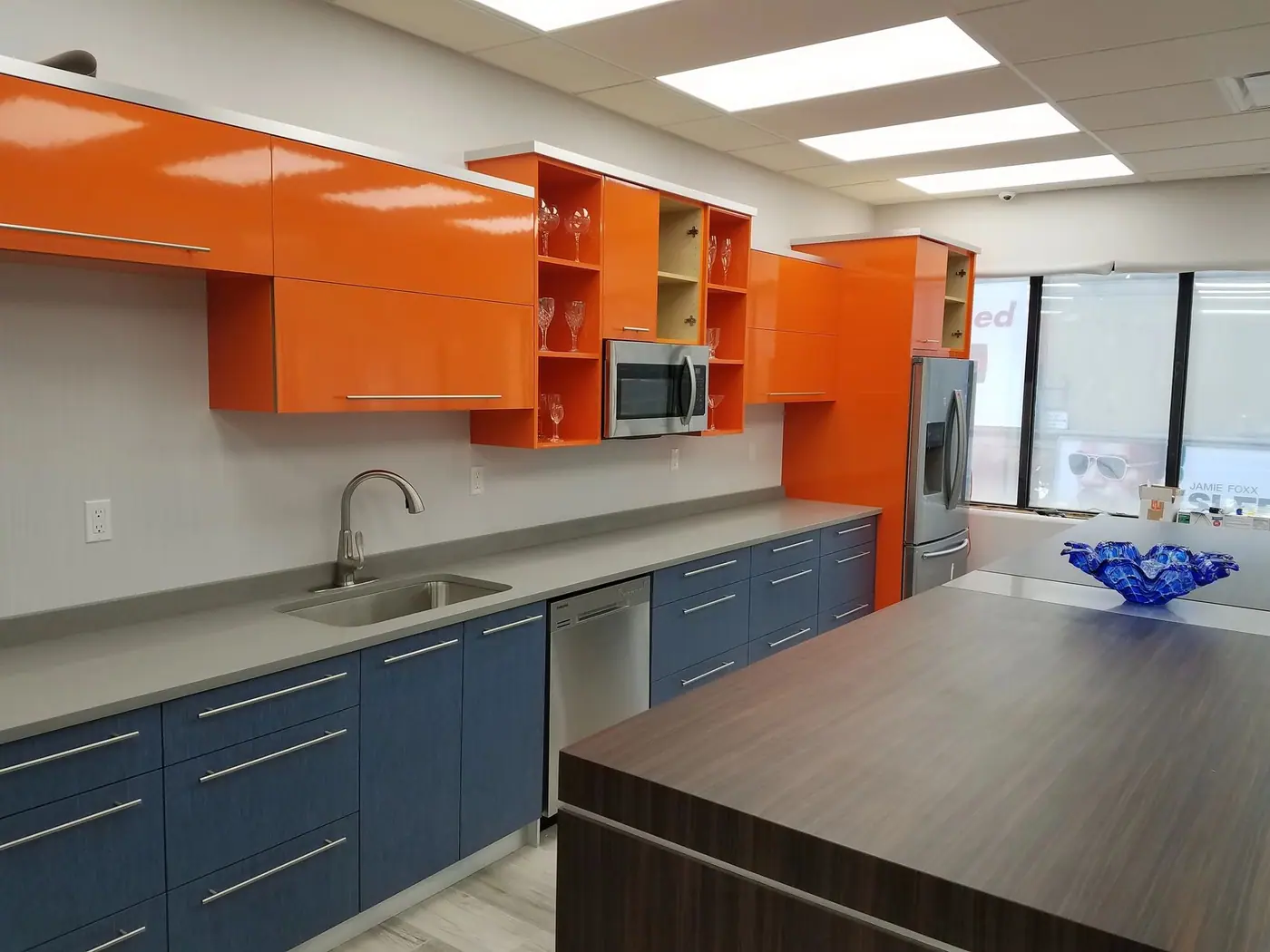 Two tone cabinetry and counter in a large office pantry