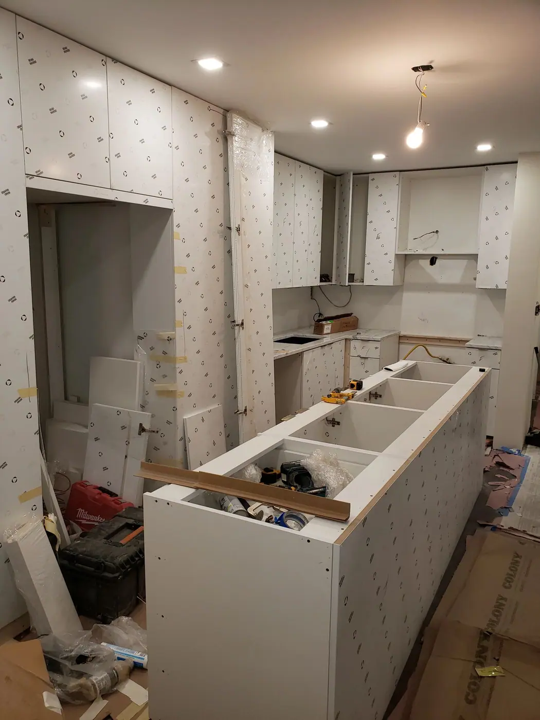 New kitchen cabinetry and island under construction in the Sutton Place condo