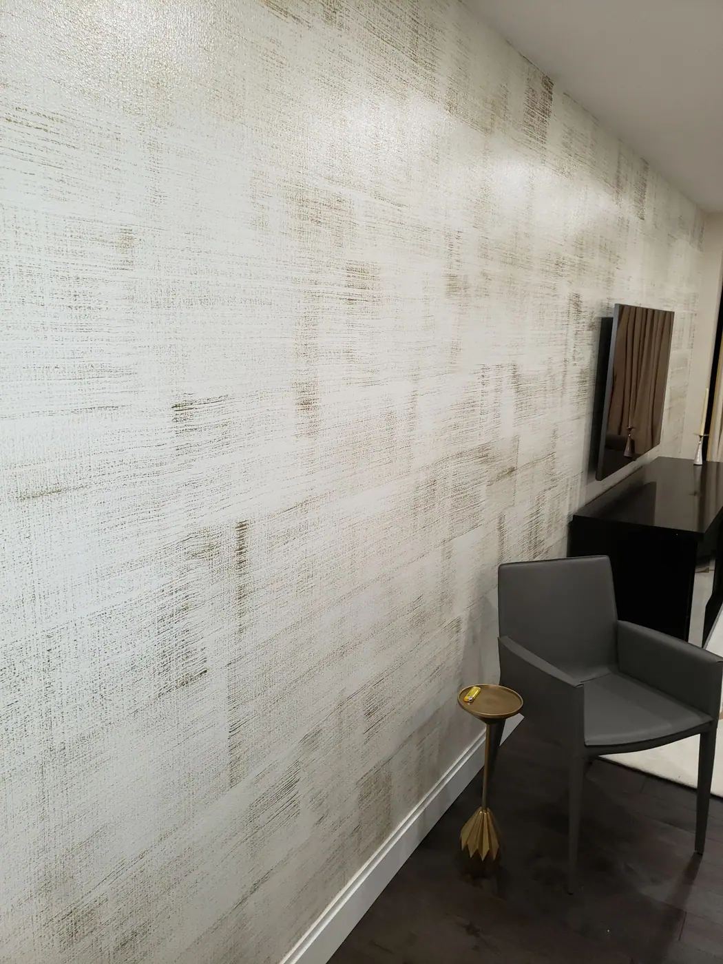 Textured wall finish and furniture in the finished Sutton Place apartment