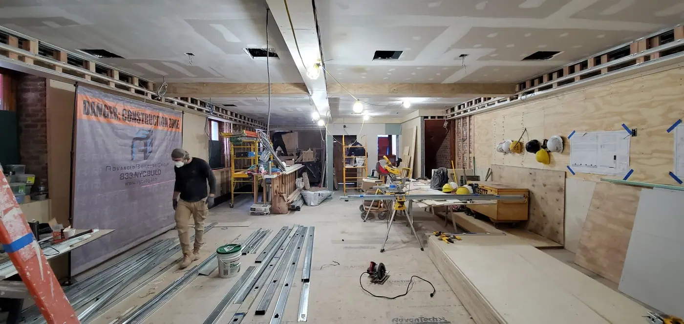Walls closed in and the ceiling grid set in the Upper East Side restaurant